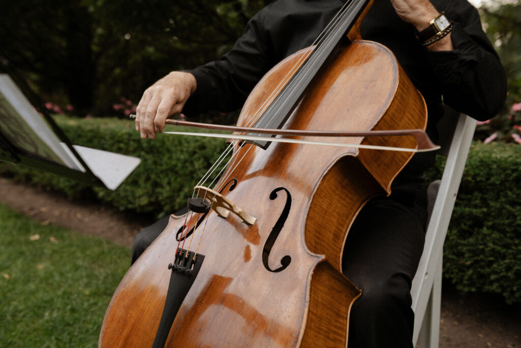 Graydon Hall Manor wedding ceremony in Toronto gardens with violinist playing