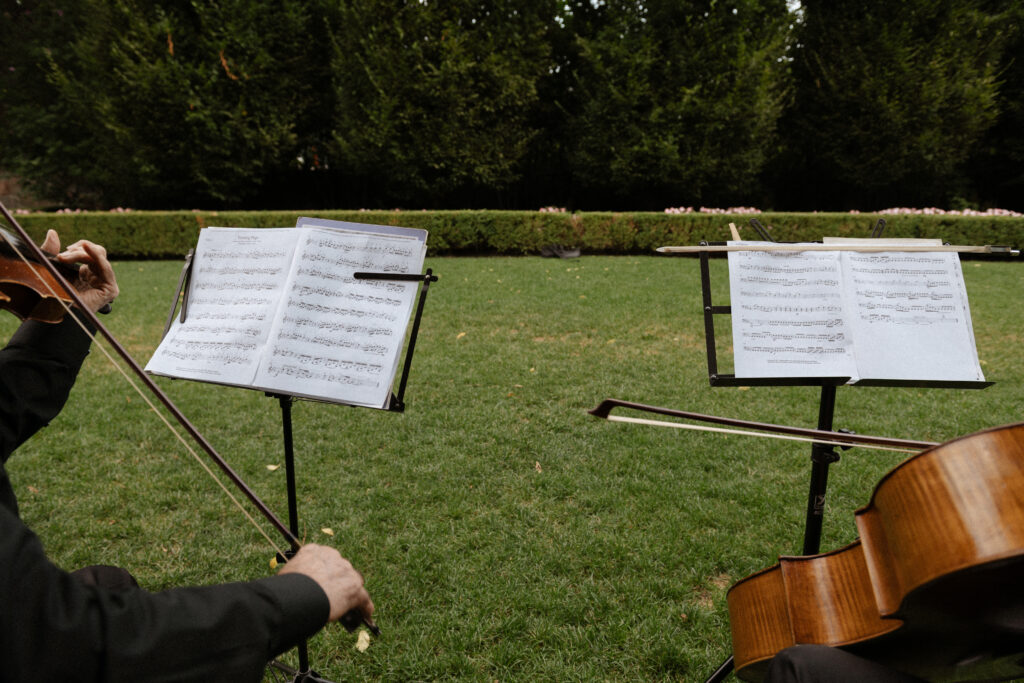 Graydon Hall Manor wedding ceremony in Toronto gardens with violinist playing